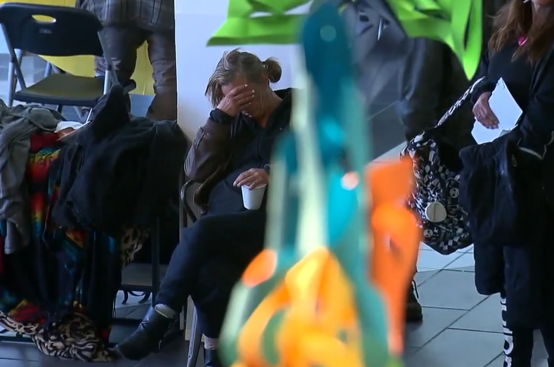 Woman sitting with hand over face